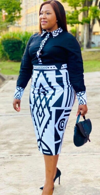 An Ankara pencil skirt with a black blouse and statement necklace