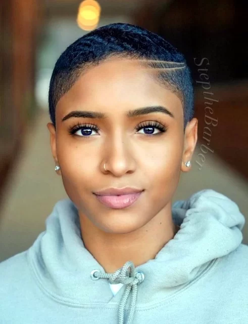 Woman with short hairstyle and hoop earring.