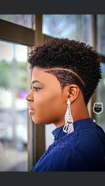 Woman with stylish haircut and elegant earrings.