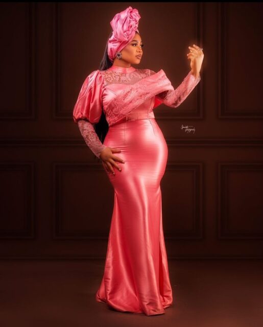 Woman in elegant pink traditional African attire.