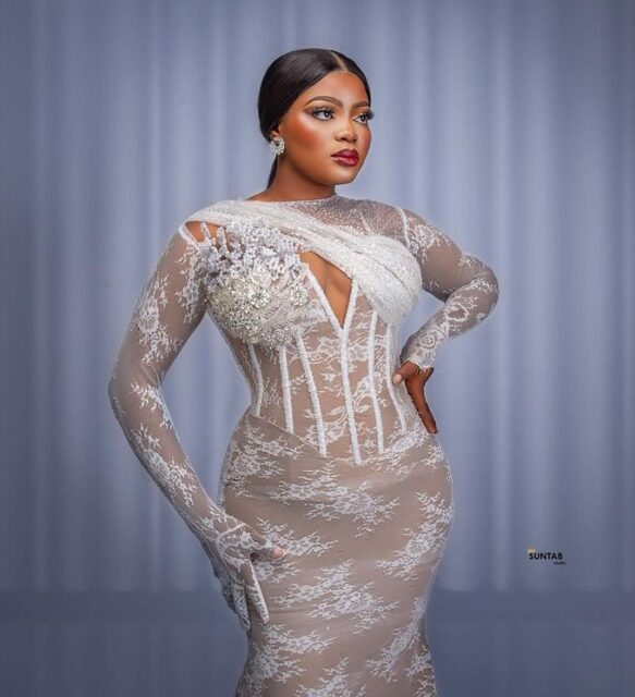 Woman in elegant white lace dress.